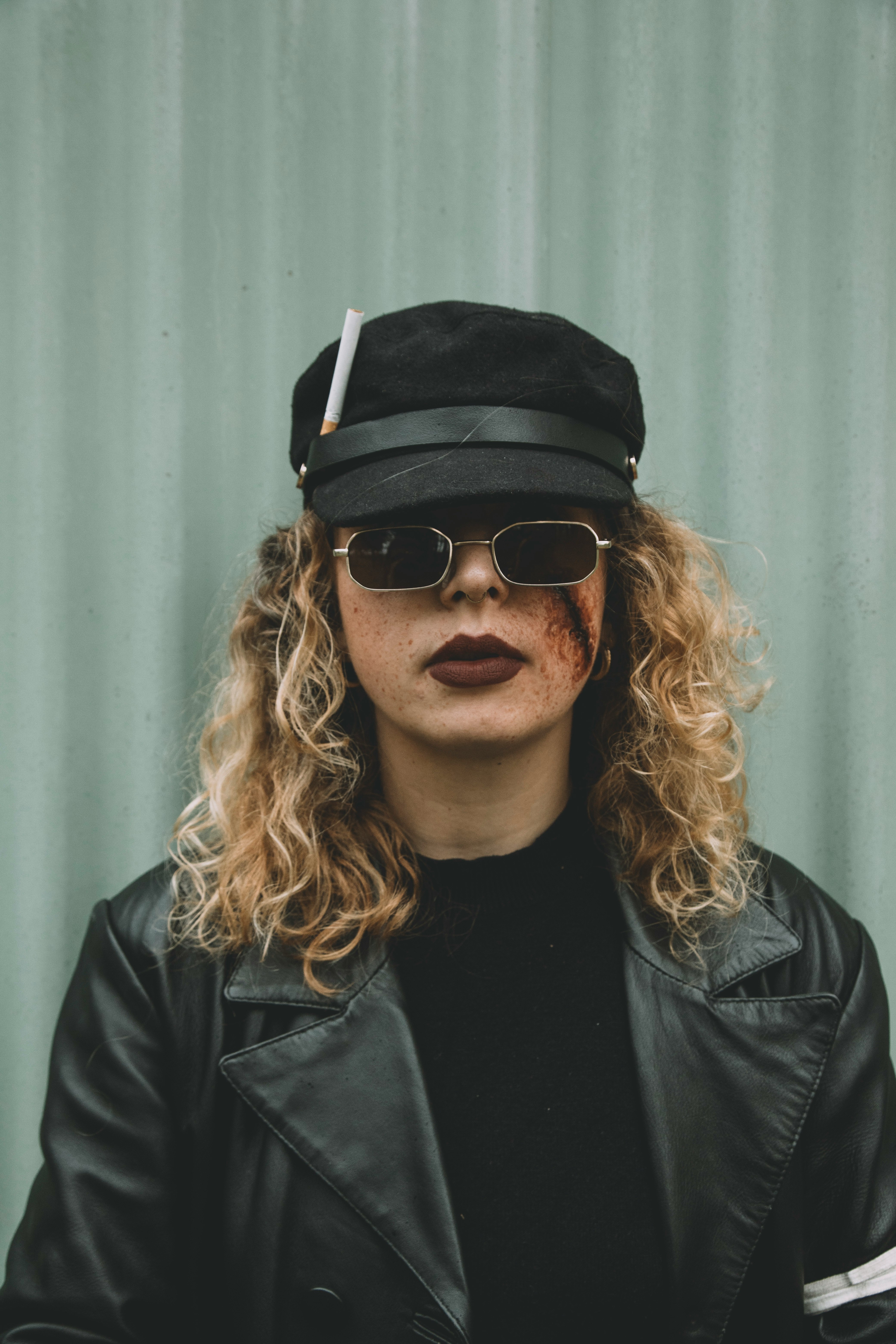 man in black leather jacket wearing black sunglasses